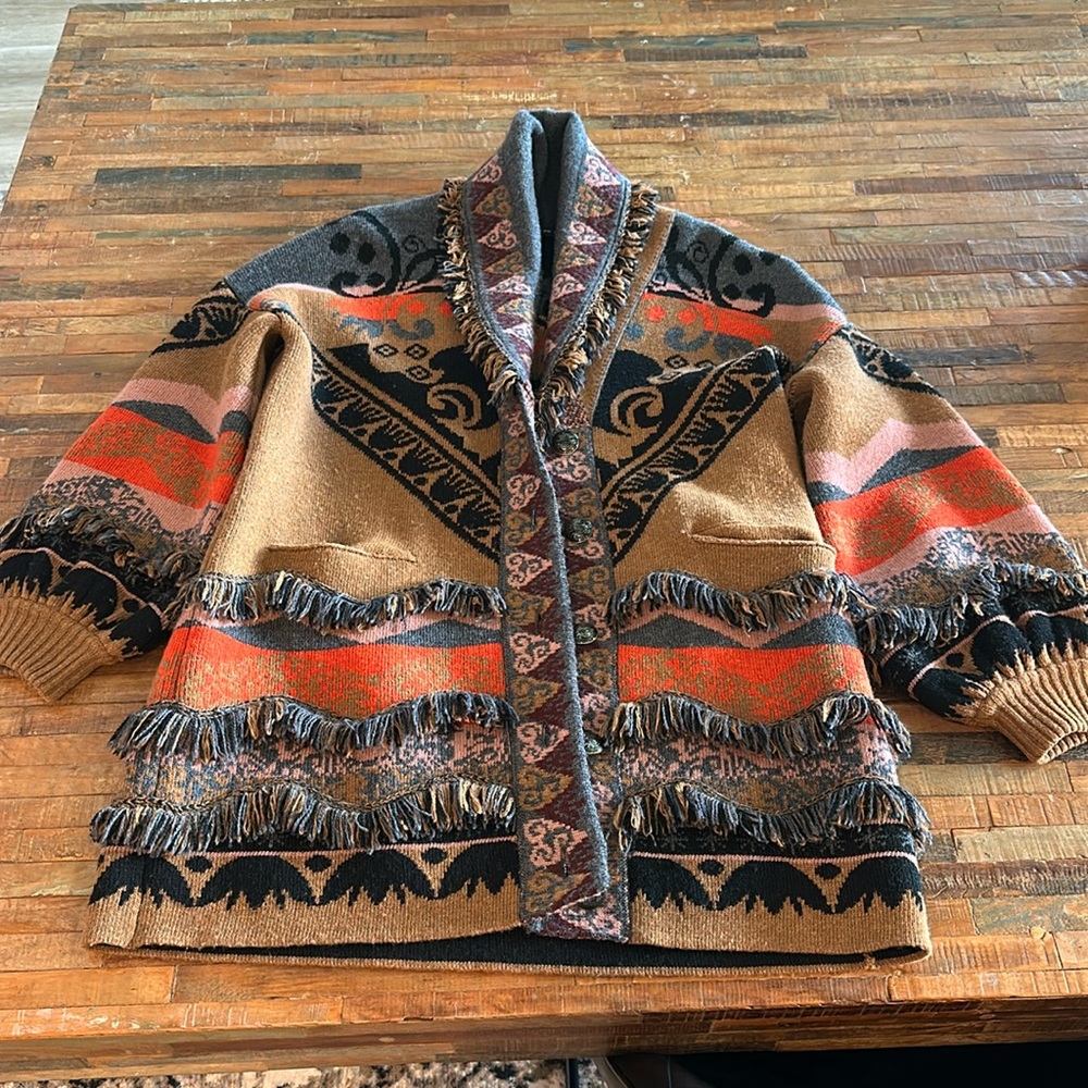 Beautiful fringe sweater jacket with special buttons.